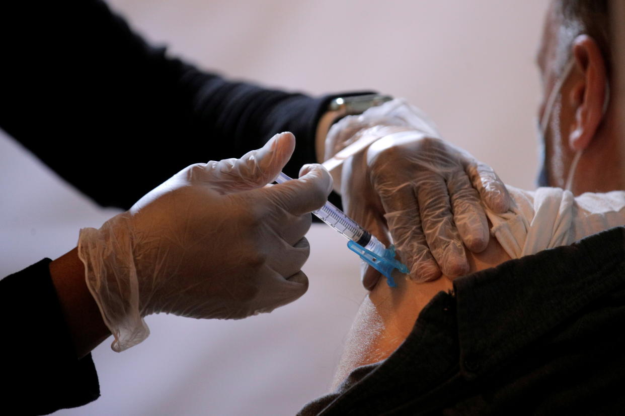 A commuter receives a shot of the Johnson & Johnson vaccine for the coronavirus disease (COVID-19) during the opening of MTA's public vaccination program at a subway station in the Brooklyn borough of New York City on May 12, 2021. (Brendan McDermid/Reuters)