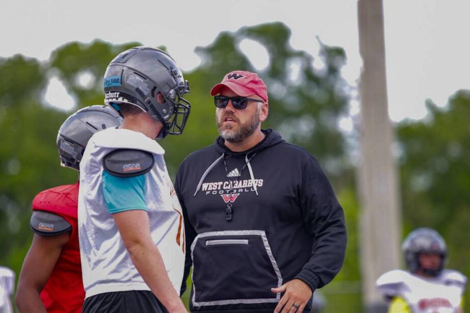 West Cabarrus head coach Brian Hinson provides a moment of reassurance to his player at the High School football prospect day recruiting showcase at Hickory Ridge High School Kelly Hood