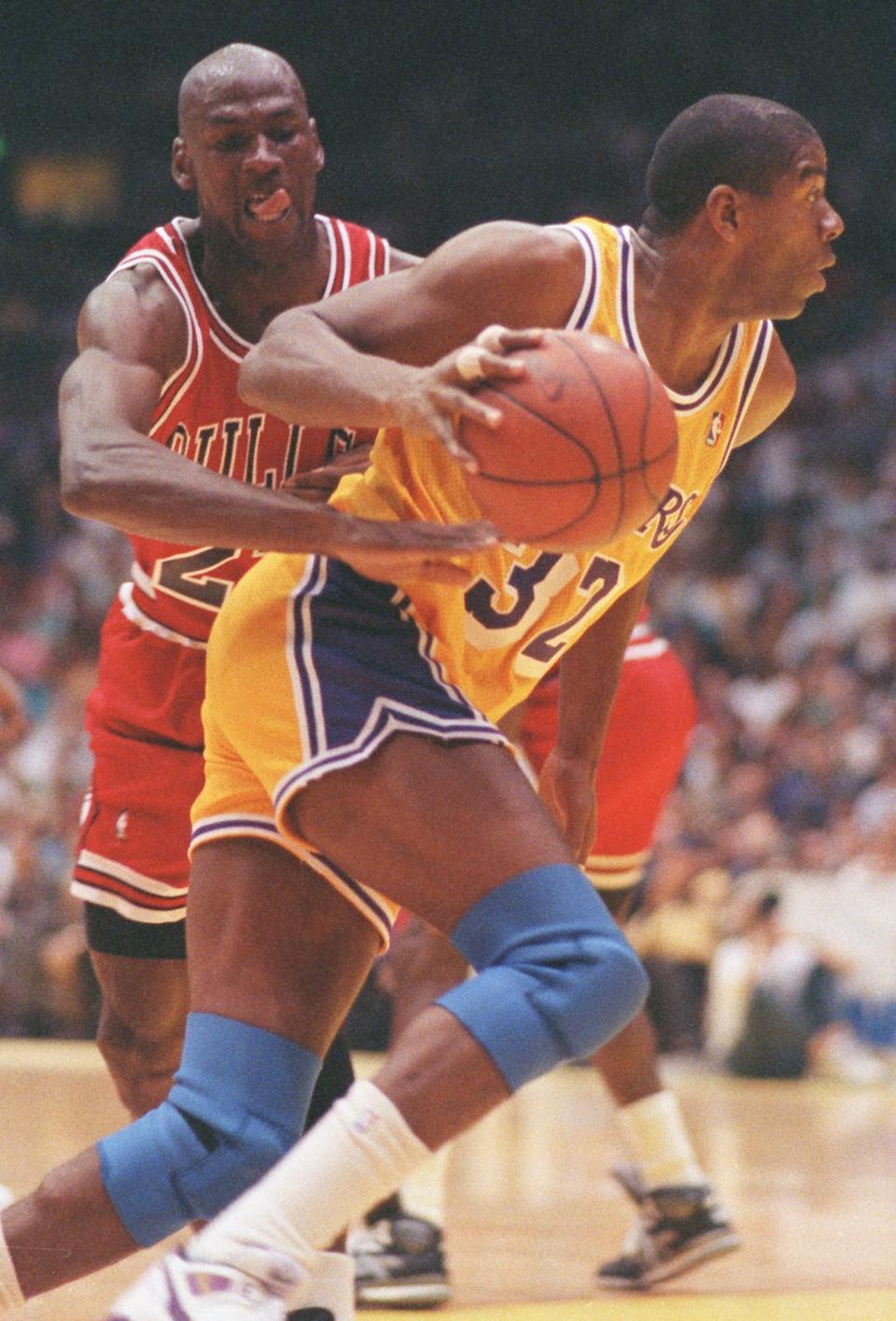 Bulls' Michael Jordan tries to reach around Lakers' Magic Johnson in Game 4 of the NBA Finals on June 10, 1991 in Inglewood, Calif.