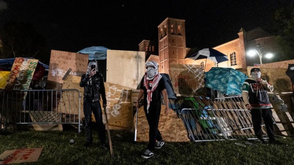 Pro-Palestine protesters rebuild a barricade on UCLA campus April 30