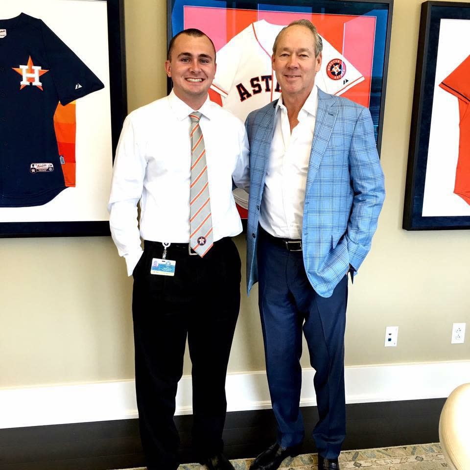 A man named Kyle McLaughlin, who may have photographed the Red Sox and Indians dugouts, is shown with Houston Astros owner Jim Crane.