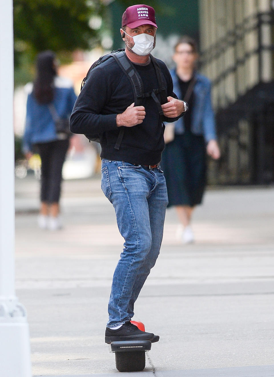 <p>Liev Schreiber takes a ride on his motorized skateboard on Tuesday in downtown N.Y.C.</p>