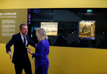 Museum director Axel Ruger and Dutch Minister of Education, Culture and Science Jet Bussemaker reveal two recovered paintings by Vincent van Gogh, which were stolen from the museum in 2002, at the van Gogh Museum in Amsterdam, Netherlands March 21, 2017. REUTERS/Michael Kooren