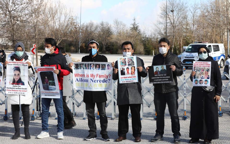 Uighurs protesting outside the Chines embassy in Turkey on Friday - GETTY IMAGES