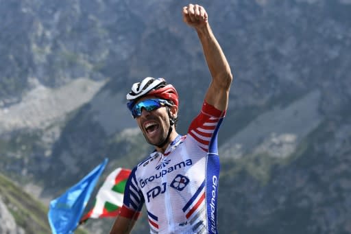 France's Thibaut Pinot raises his fist in victory after stage 14