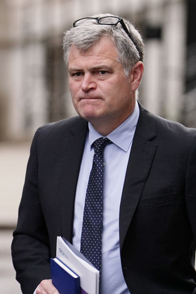 David Whitehouse in suit and tie, with his glasses on his head