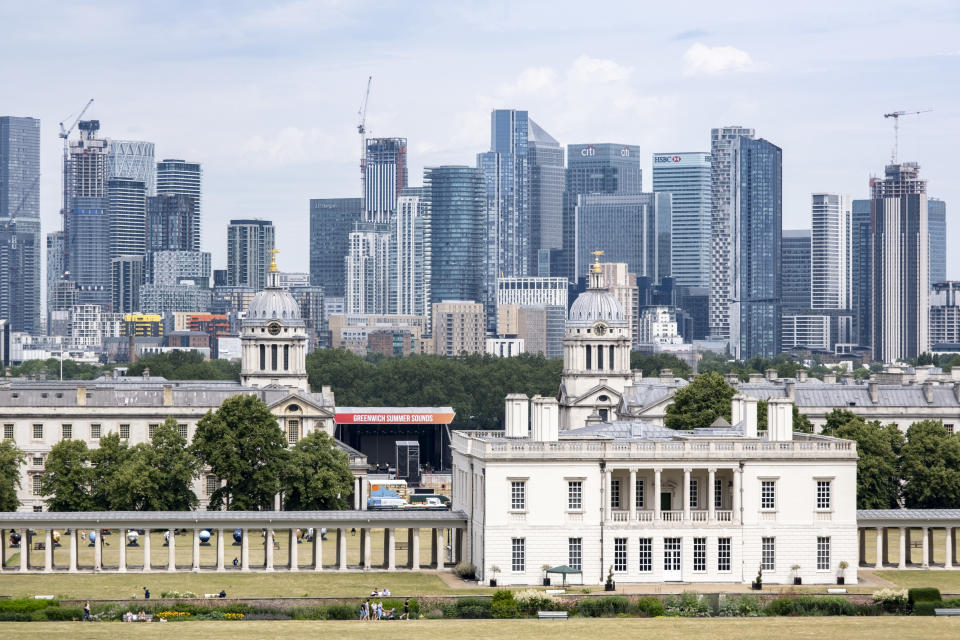 Skyline view of Canary Wharf financial district beyond the National Maritime Museum and the Old Royal Naval College from the viewpoint in Greenwich Park on 8th July 2023 in London, United Kingdom. Canary Wharf is an area located near the Isle of Dogs in the London Borough of Tower Hamlets and is defined by the Greater London Authority as being part of London's central business district. Along with the City of London, it constitutes one of the main financial centres in the United Kingdom and the world, containing many high-rise buildings including the third-tallest in the UK, One Canada Square. (photo by Mike Kemp/In Pictures via Getty Images)