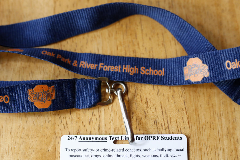The back of a student ID from Oak Park and River Forest High School is shown Wednesday, Sept. 7, 2022, in Oak Park, Ill. Students are encouraged to text anonymous tips about safety and crime concerns to school staff. As concerns about violence in schools have grown, several states also have established their own tip lines to gather this sort of information. It's one of several tactics security and law enforcement are using to try to keep students and school staff safe. (AP Photo/Martha Irvine)