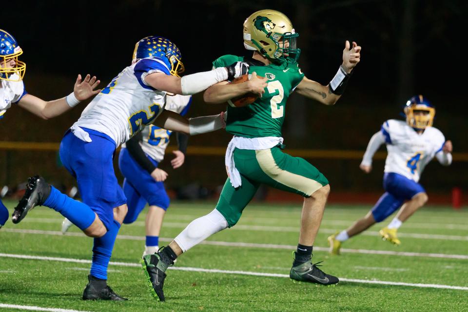 GNB Voc Tech’s Cam Lynch escapes a tackle from Assabet’s Chris Hatch during the State Vocational Large semifinal.