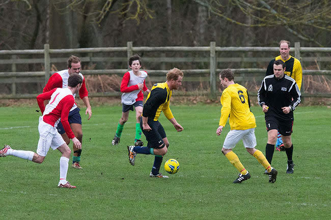 Prince Harry and Prince William playing football