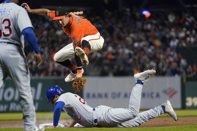 Chicago Cubs' Nick Madrigal, right, slides into second base next to San  Francisco Giants second baseman Thairo Estrada after Cubs' Seiya Suzuki  walked during the first inning of a baseball game in