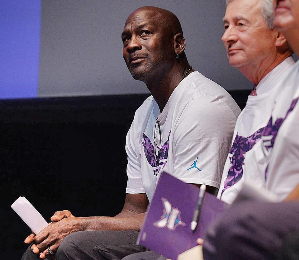 Michael Jordan, left, waits to be introduced to officially announce an edition to their Day of Service project, the ‘Swarm to Service”, which will benefit military vets in Charlotte Monday, June 22, 2015