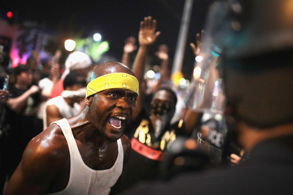 <p>SEPT. 16, 2017 – Demonstrators confront police while protesting the acquittal of former St. Louis police officer Jason Stockley in St. Louis, Missouri. Dozens of business windows were smashed and at least two police cars were damaged during a second day of protests following the acquittal of Stockley, who was been charged with first-degree murder last year following the 2011 on-duty shooting of Anthony Lamar Smith. (Photo: Scott Olson/Getty Images) </p>