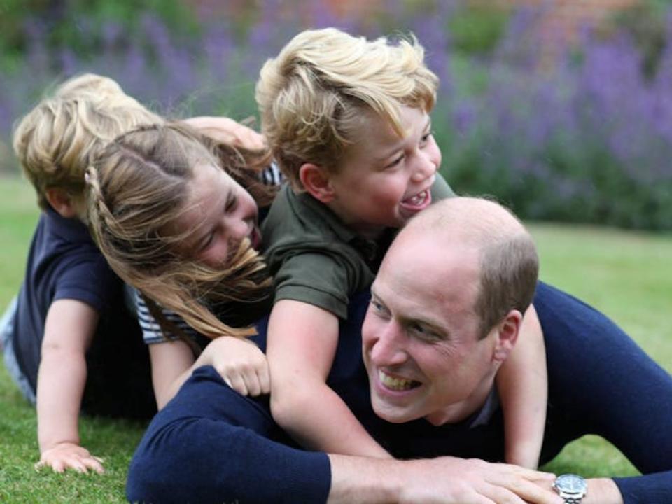 Prince William tackled by his kids in a family portrait