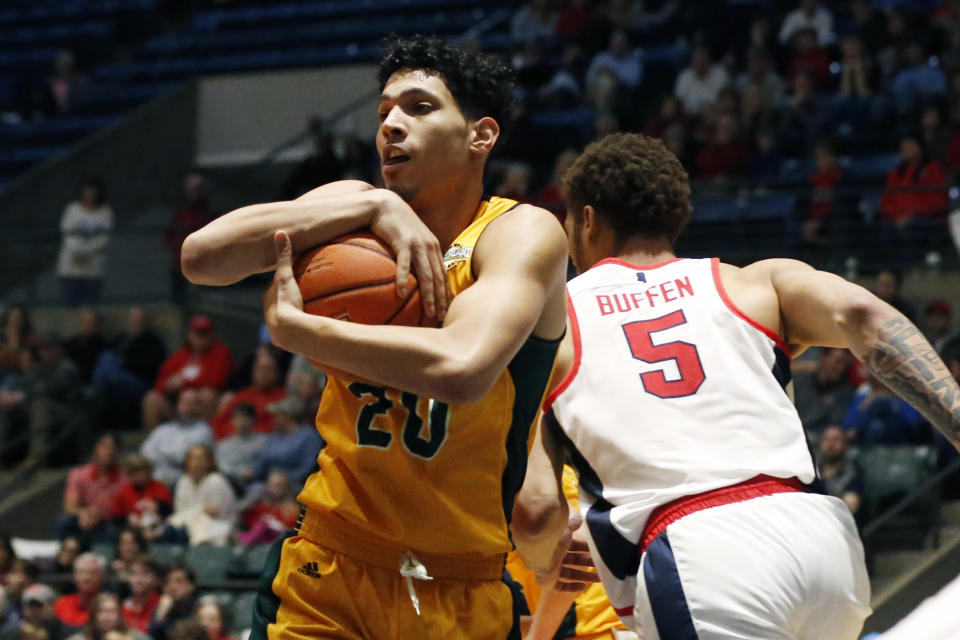 Southeastern Louisiana forward Brandon Gonzalez (20) holds on to a rebound as Mississippi forward KJ Buffen (5) rushes past during the second half of an NCAA college basketball game, Saturday, Dec. 21, 2019, in Jackson, Miss. Mississippi won 83-76.(AP Photo/Rogelio V. Solis)