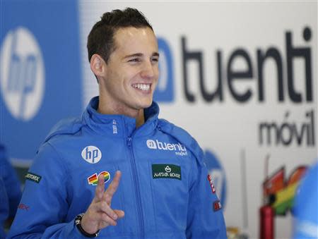 Kalex Moto2 rider Pol Espargaro of Spain poses for photos at his team's garage ahead of Sunday's Japanese Grand Prix in Motegi, north of Tokyo October 25, 2013. REUTERS/Toru Hanai