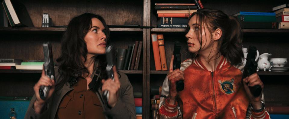 A deadly assassin (Karen Gillan, right) and her mom (Lena Headey) 
take on bad guys in the Netflix action thriller "Gunpowder Milkshake."