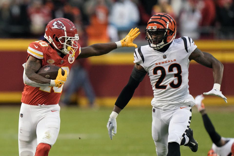 Kansas City Chiefs running back Isiah Pacheco runs for a first down as Cincinnati Bengals safety Dax Hill (23) defends during the first half of an NFL football game Sunday, Dec. 31, 2023, in Kansas City, Mo. (AP Photo/Charlie Riedel)