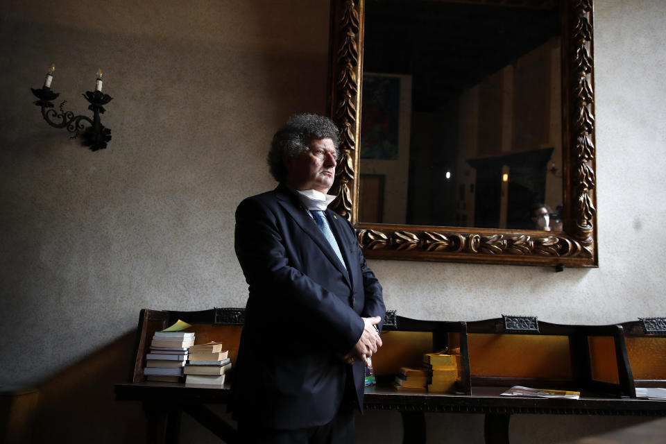 In this picture taken on Wednesday, May 13, 2020, head of the Venice Hotel Association Claudio Scarpa stands as he waits for an Associated Press interview in Venice, Italy. Venetians are rethinking their city in the quiet brought by the coronavirus pandemic. For years, the unbridled success of Venice's tourism industry threatened to ruin the things that made it an attractive destination to begin with. Now the pandemic has ground to a halt Italy’s most-visited city, stopped the flow of 3 billion euros in annual tourism-related revenue and devastated the city's economy. (AP Photo/Antonio Calanni)