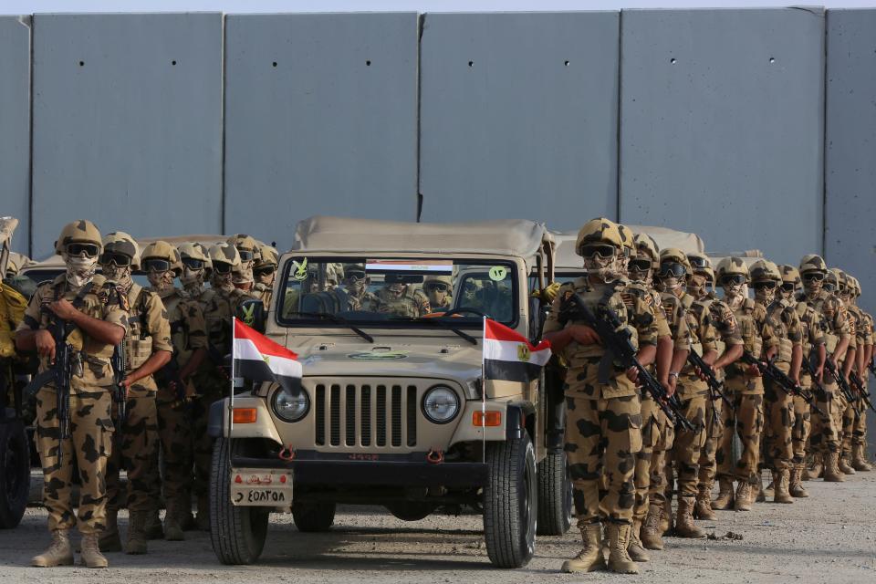 Egyptian military personnel stand alert at the Rafah border.