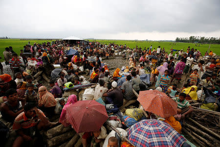 Rohingya refugees sit as they are temporarily held by the Border Guard Bangladesh (BGB) in an open area after crossing the border, in Teknaf, Bangladesh, September 3, 2017. REUTERS/Mohammad Ponir Hossain