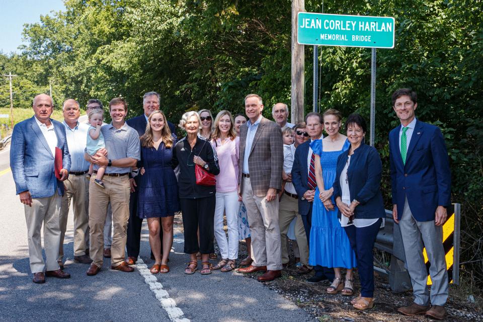 Friends and family pose for a photo after dedicating a bridge in memory of Jean Corley Harlan in Columbia, Tenn. on Tuesday, July 11, 2023. 