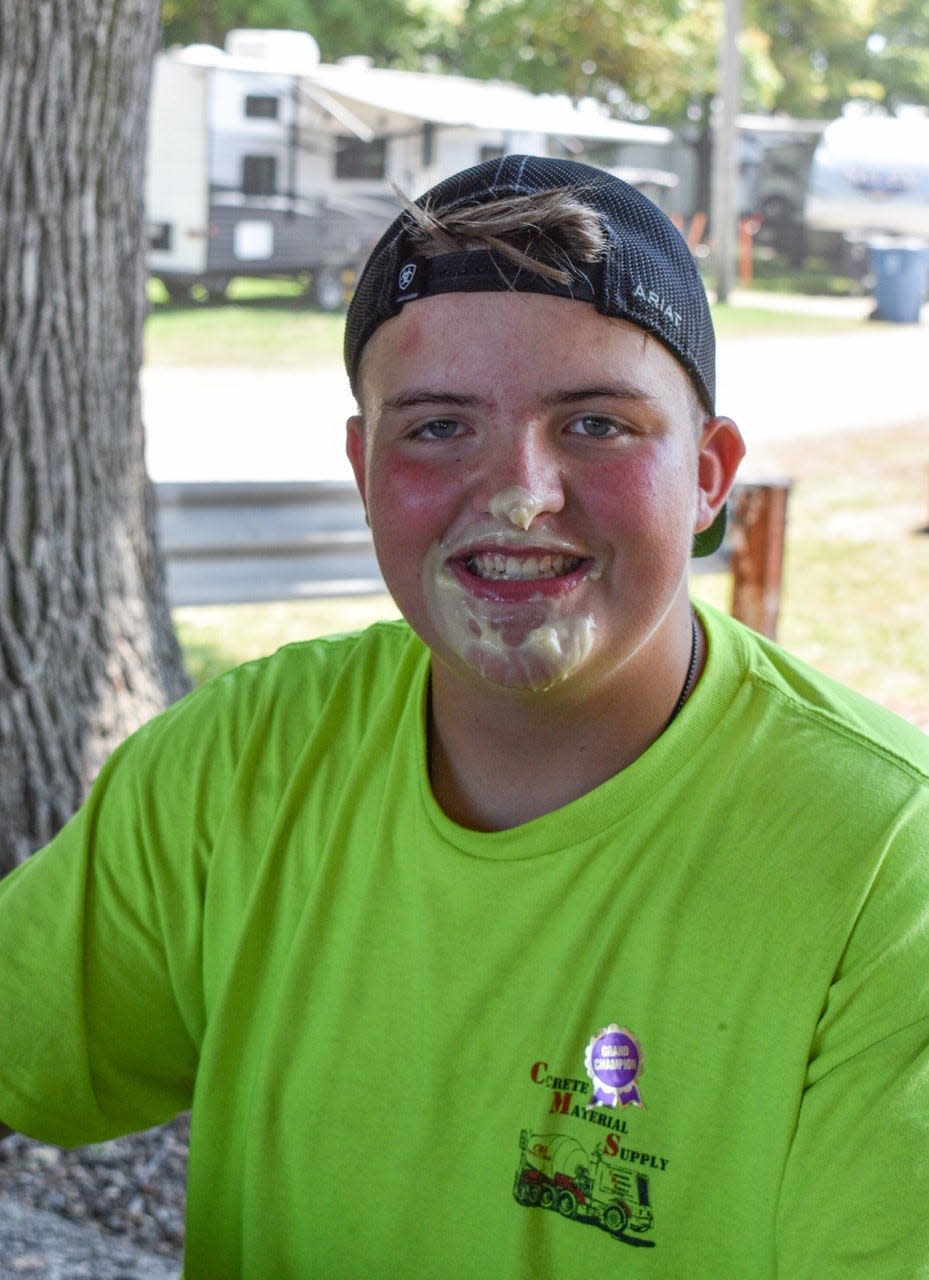 Kase Knecht, 13, wears his Grand Champion sticker – and a lot of pudding – after winning the Jr. Fair pie-eating contest on July 19.