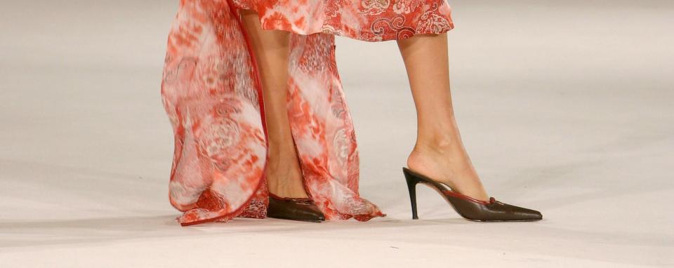 A shot of a pair of pointed toe heels on the runway