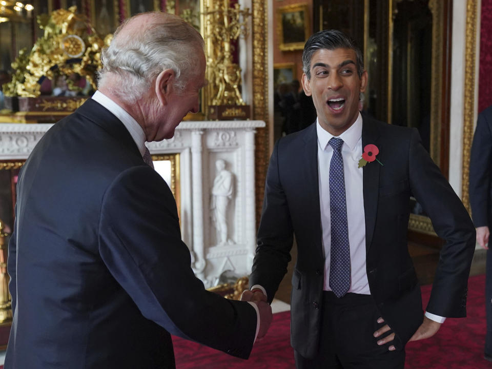 FILE - Britain's King Charles III speaks with Prime Minister Rishi Sunak during a reception at Buckingham Palace, London, Nov. 4, 2022, ahead of the COP27 Summit. (Jonathan Brady/Pool Photo via AP, File)