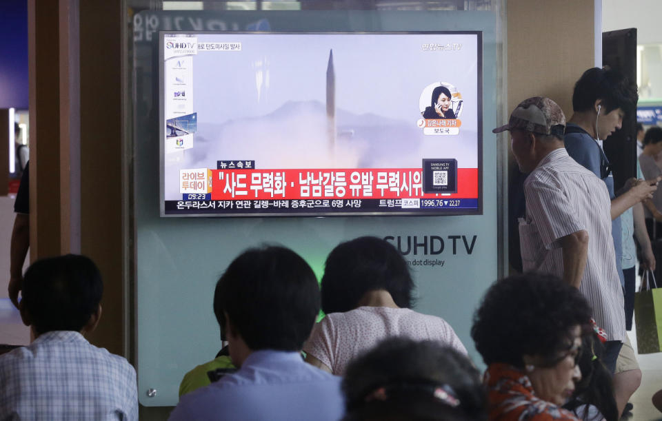 South Koreans watch a TV news program airing file footage of a North Korean rocket launch at the Seoul Railway Station in Seoul, South Korea, Wednesday, Aug. 3, 2016. (AP Photo/Ahn Young-joon)