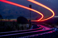 Long time exposure photo shows a regional train approaching the train station of Wehrheim near Frankfurt, Germany, early Thursday, Nov. 24, 2022. (AP Photo/Michael Probst)