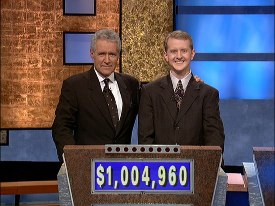 Alex Trebek poses with contestant Ken Jennings after he earned more than $1 million in 2004. (Photo: Jeopardy Productions via Getty Images) 