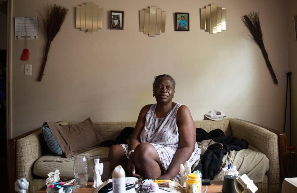 Sharon Logan watches television in the living room of her apartment, in Greenville, Tuesday, June 7, 2022.