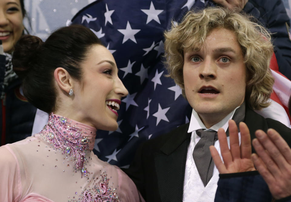 Meryl Davis and Charlie White of the United States wait for their results after competing in the team ice dance short dance figure skating competition at the Iceberg Skating Palace during the 2014 Winter Olympics, Saturday, Feb. 8, 2014, in Sochi, Russia. (AP Photo/Darron Cummings, Pool)