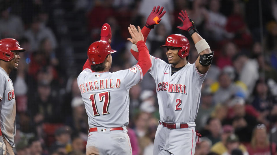 Cincinnati Reds' Jose Barrero (2) celebrates with Stuart Fairchild (11) after his grand slam during the seventh inning of a baseball game at Fenway Park, Tuesday, May 30, 2023, in Boston. (AP Photo/Charles Krupa)