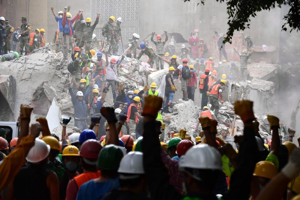 <p>In September 2017, two days after a 7.1 magnitude earthquake shook Mexico City, rescuers make the group signal for silence during the search for survivors. </p>