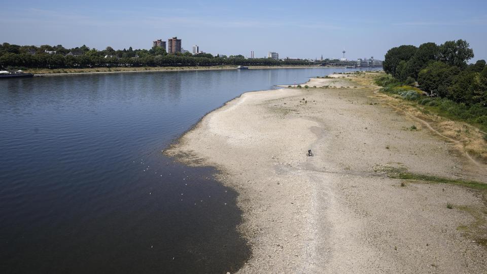 The river Rhine is pictured with low water in Cologne, Germany, Wednesday, Aug. 10, 2022. The low water levels are threatening Germany's industry as more and more ships are unable to traverse the key waterway. Severe drought will worsen in Europe in August as a hot and dry summer persists. (AP Photo/Martin Meissner)