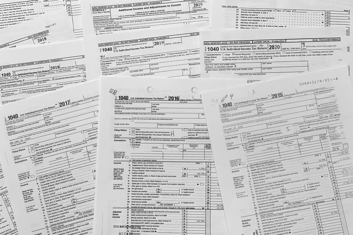 Copies of former President Donald Trump and former first lady Melania Trump individual tax returns for the years 2015 to 2020, released by the Democratic-controlled House Ways and Means Committee, are photographed Friday, Dec. 30, 2022. The returns, which include redactions of some personal sensitive information such as Social Security and bank account numbers, span nearly 6,000 pages, including more than 2,700 pages of individual returns, and more than 3,000 pages in returns for Trump’s business entities. (AP Photo/Jon Elswick)