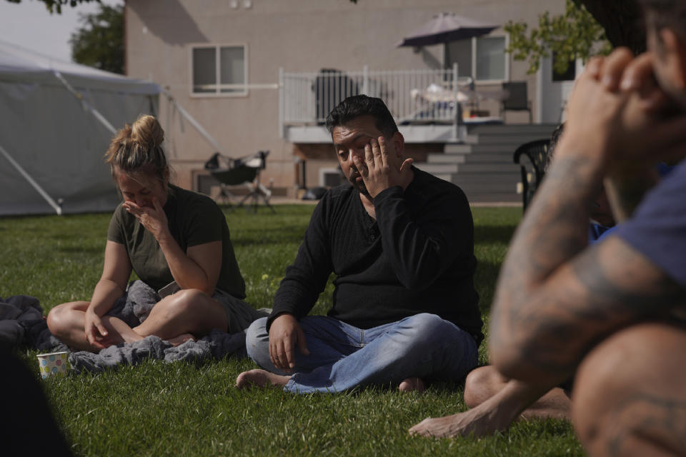 Lorenzo Gonzales, center, cries as he shares parts of his ayahuasca experience during an integration circle on the third day of a Hummingbird Church retreat, in Hildale, Utah, on Sunday, Oct. 16, 2022. Gonzales and his wife decided to try ayahuasca in hopes that it would help cure his physical and mental ailments. (AP Photo/Jessie Wardarski)
