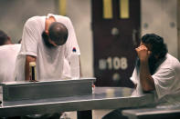 U.S. NAVAL BASE GUANTANAMO, CUBA - MAY 31: (EDITORS NOTE: IMAGE REVIEWED BY U.S. MILITARY PRIOR TO TRANSMISSION) Detainees sit together at a metal table inside Camp 6 detention facility on May 31, 2009 at U.S. Naval Base Guantanamo Bay, Cuba. Camp six is a medium-security facility with the capability of holding in a maximum-security portion of its roughly 60 detainees, based on their compliance with rules, according to the U.S. military. Former child soldier Omar Khadr, the Canadian citizen captured on the battlefield in Afghanistan in 2002 is expected to appear in a military commission hearing tomorrow with the charge of providing support to terrorism after allegedly throwing a grenade that killed a US soldier. This trial marks the first hearing of the Bush-era war crimes tribunals to take place under U.S. President Barack Obama. (Photo by Brennan Linsley-Pool/Getty Images)