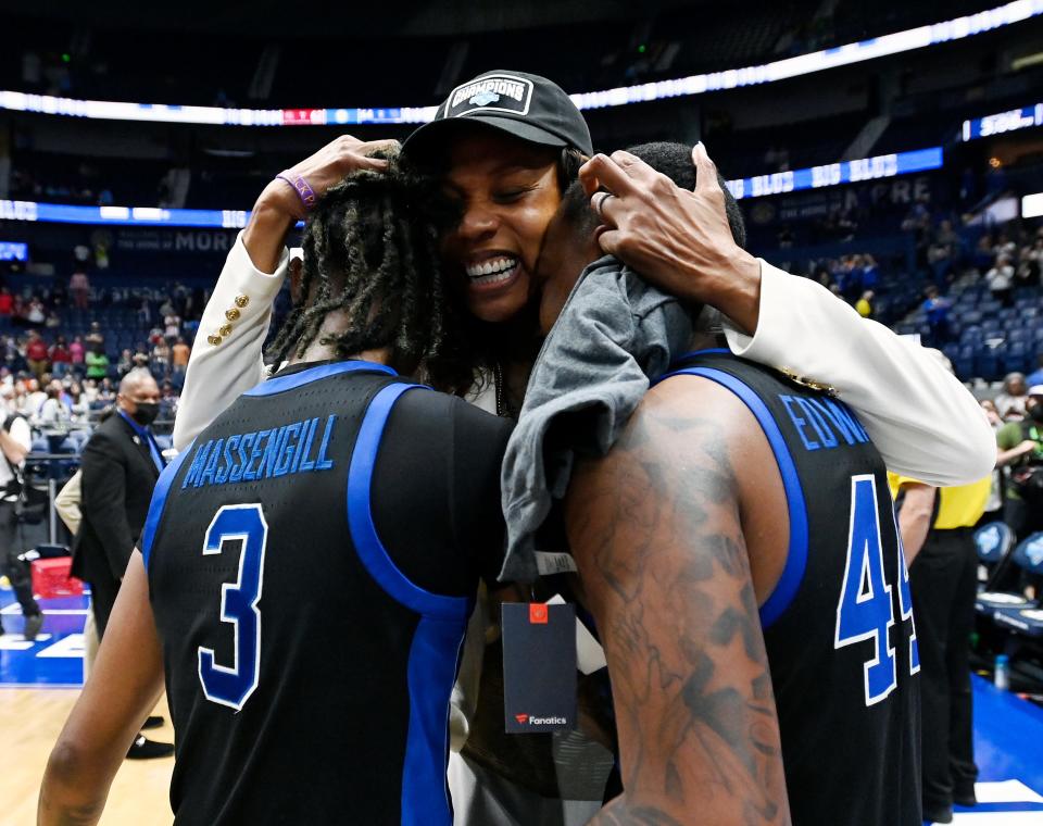 Kentucky head coach Kyra Elzy celebrates with Jazmine Massengill (3) and Dre'una Edwards (44) following the team’s victory over South Carolina in an NCAA college basketball championship game at the women’s Southeastern Conference tournament, Sunday, March 6, 2022, in Nashville, Tenn.