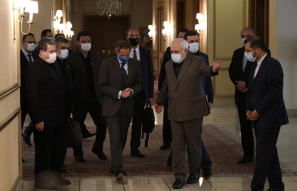 Iran's Foreign Minister Mohammad Javad Zarif, center right, welcomes Director General of International Atomic Energy Agency, IAEA, Rafael Mariano Grossi for their meeting in Tehran, Iran, Tuesday, Aug. 25, 2020. Grossi arrived in Iran on Monday to press for access to sites where authorities are thought to have stored or used undeclared nuclear material. (AP Photo/Vahid Salemi)