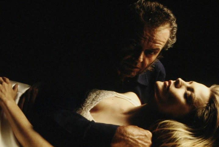 A man holds a sleeping woman in Wolf.