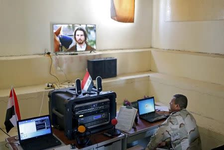 An Iraqi soldier works at a radio station at Makhmour base, Iraq, April 17, 2016. REUTERS/Ahmed Jadallah/File Photo