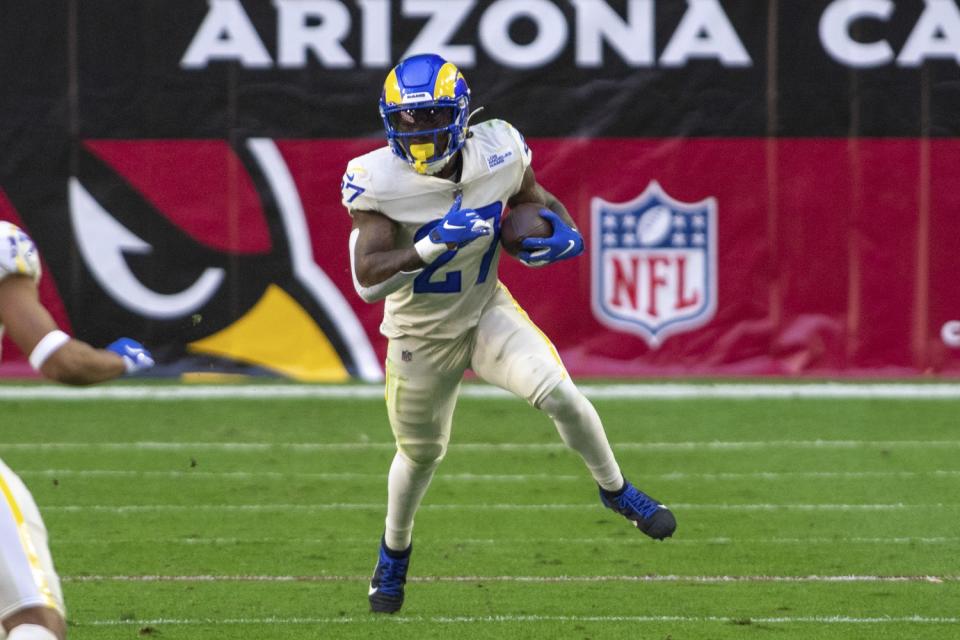 Rams running back Darrell Henderson (27) carries the football against the Arizona Cardinals in December.