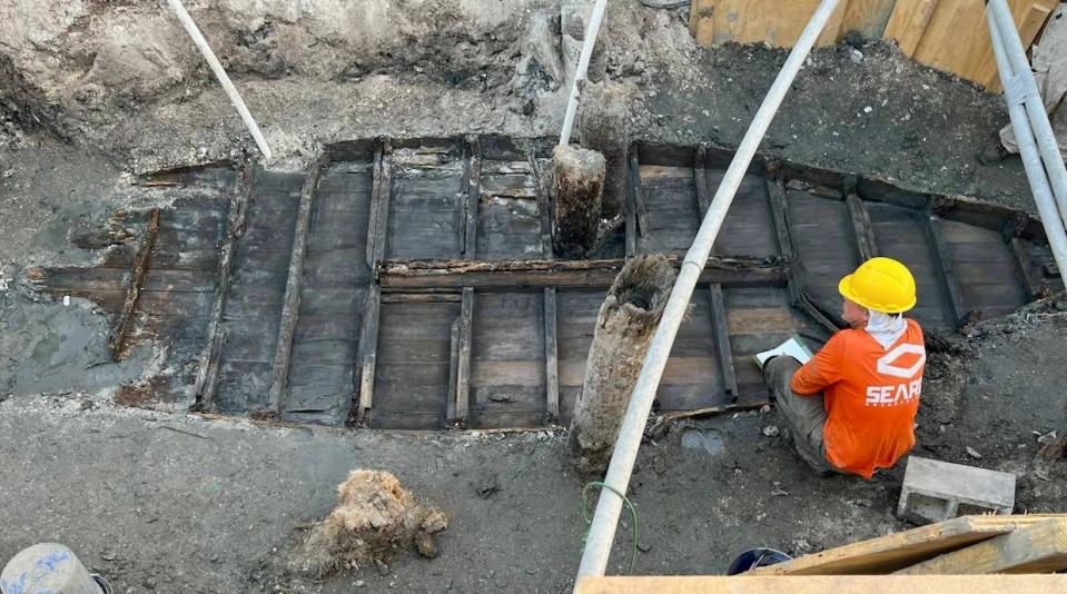 Crews painstakingly removed mud, layer by layer, to expose a historic vessel unearthed during a drainage construction project in St. Augustine.