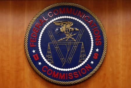 The Federal Communications Commission (FCC) logo is seen before the FCC Net Neutrality hearing in Washington February 26, 2015. REUTERS/Yuri Gripas