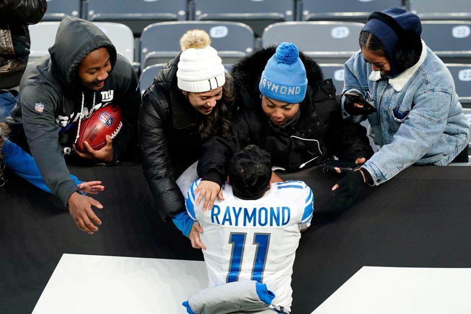Detroit Lions receiver Kalif Raymond celebrates with family after the 20-17 win over the New York Jets at MetLife Stadium on Sunday, Dec. 18, 2022 in East Rutherford, New Jersey.