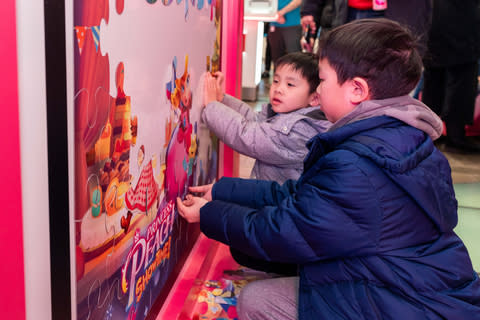 In this photo provided by Nintendo of America, fans gather at the Nintendo New York Store at Rockefeller Center to celebrate the game's release of Princess Peach: Showtime. Featuring theatrical decorations, gameplay, and activities.