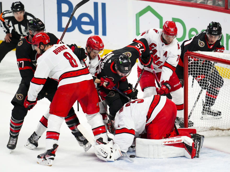 Carolina Hurricanes goaltender Frederik Andersen (31) covers the puck while taking on the Ottawa Senators during the first period of an NHL hockey game in Ottawa, Ontario, Monday, April 10, 2023. (Sean Kilpatrick/The Canadian Press via AP)